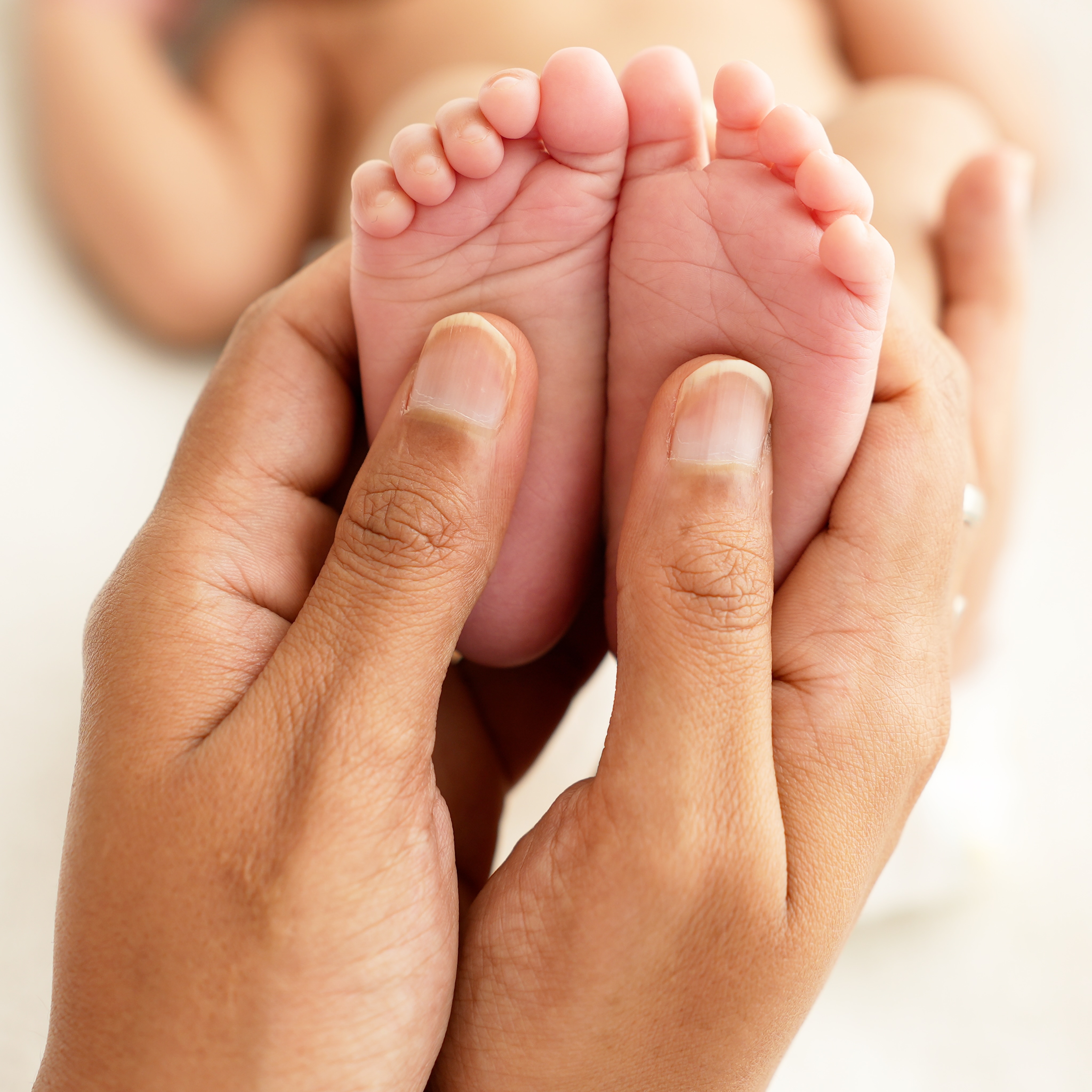 Tiny feet in parent hands