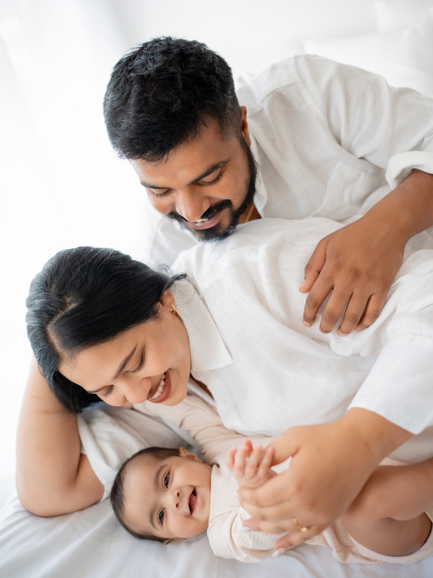 Family cuddle on bed